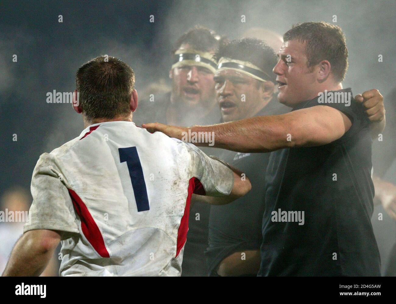 New Zealand All Blacks Tony Woodcock (R), Keven Mealamu and Carl Hayman (2nd left) push Englands Trevor Woodman (L) away after pushing Englands scrum off the ball during their rugby test in Dunedin June 12, 2004. New Zealand won the first of the two match rugby test series 36-3. REUTERS/Simon Baker  SB/CP Stock Photo