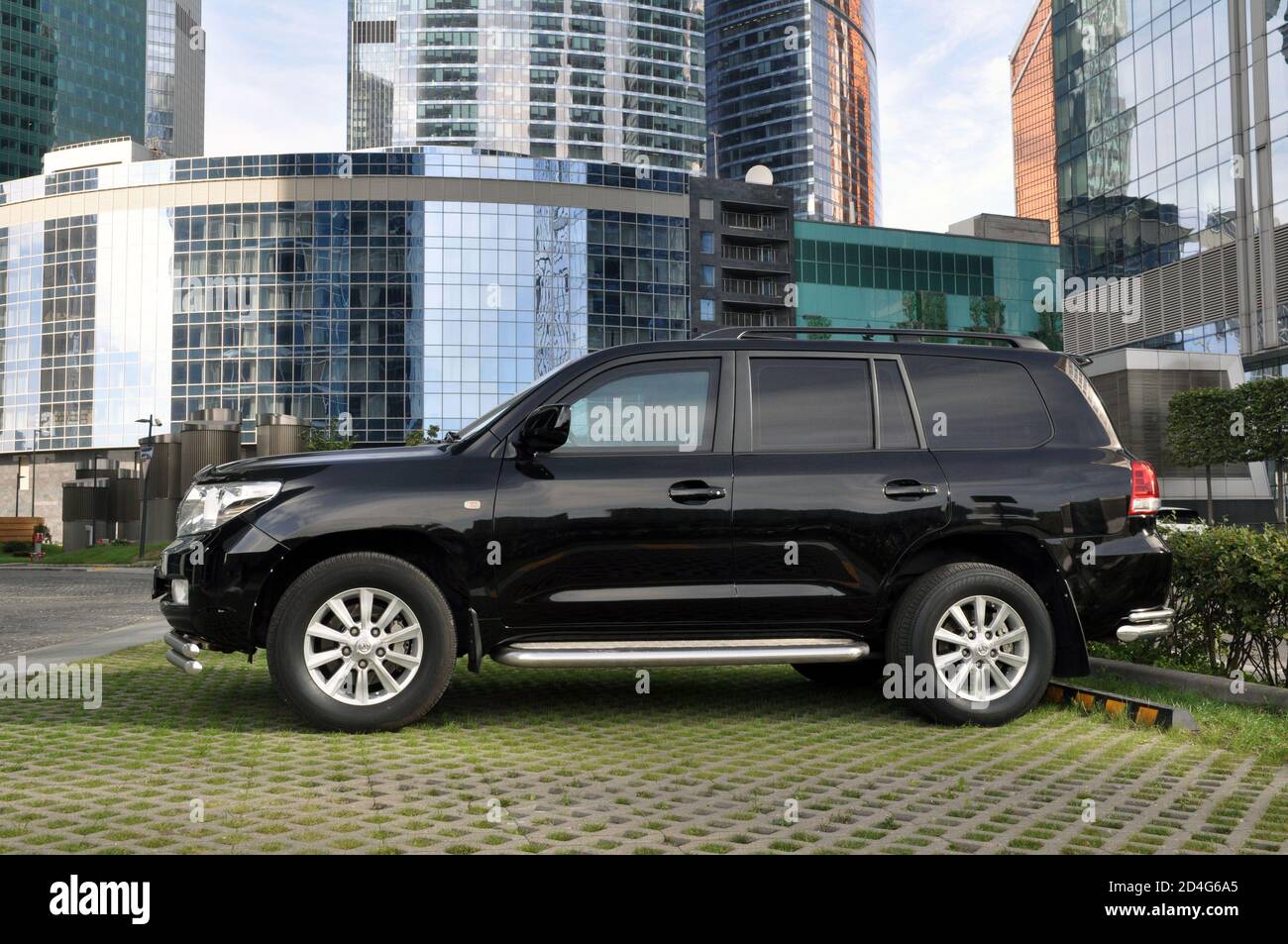Toyota Land Cruiser is parked in a public ecological parking in the Moscow city business center. Stock Photo