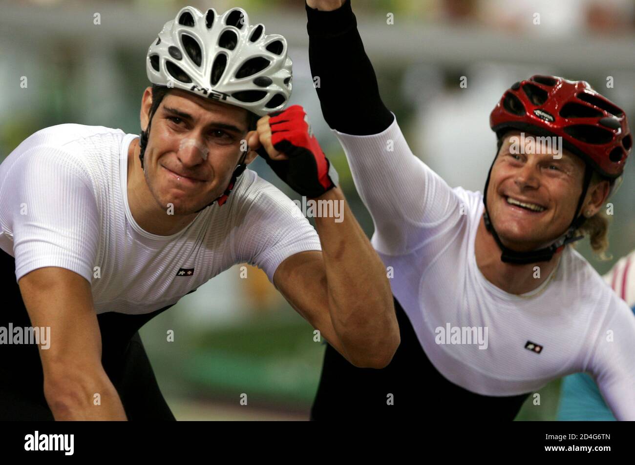 Franco Marvulli and Bruno Risi (R) of Switzerland celebrate their silver medal in the men's madison race at the Athens 2004 Olympic Summer Games track cycling competition August 25, 2004. Stock Photo