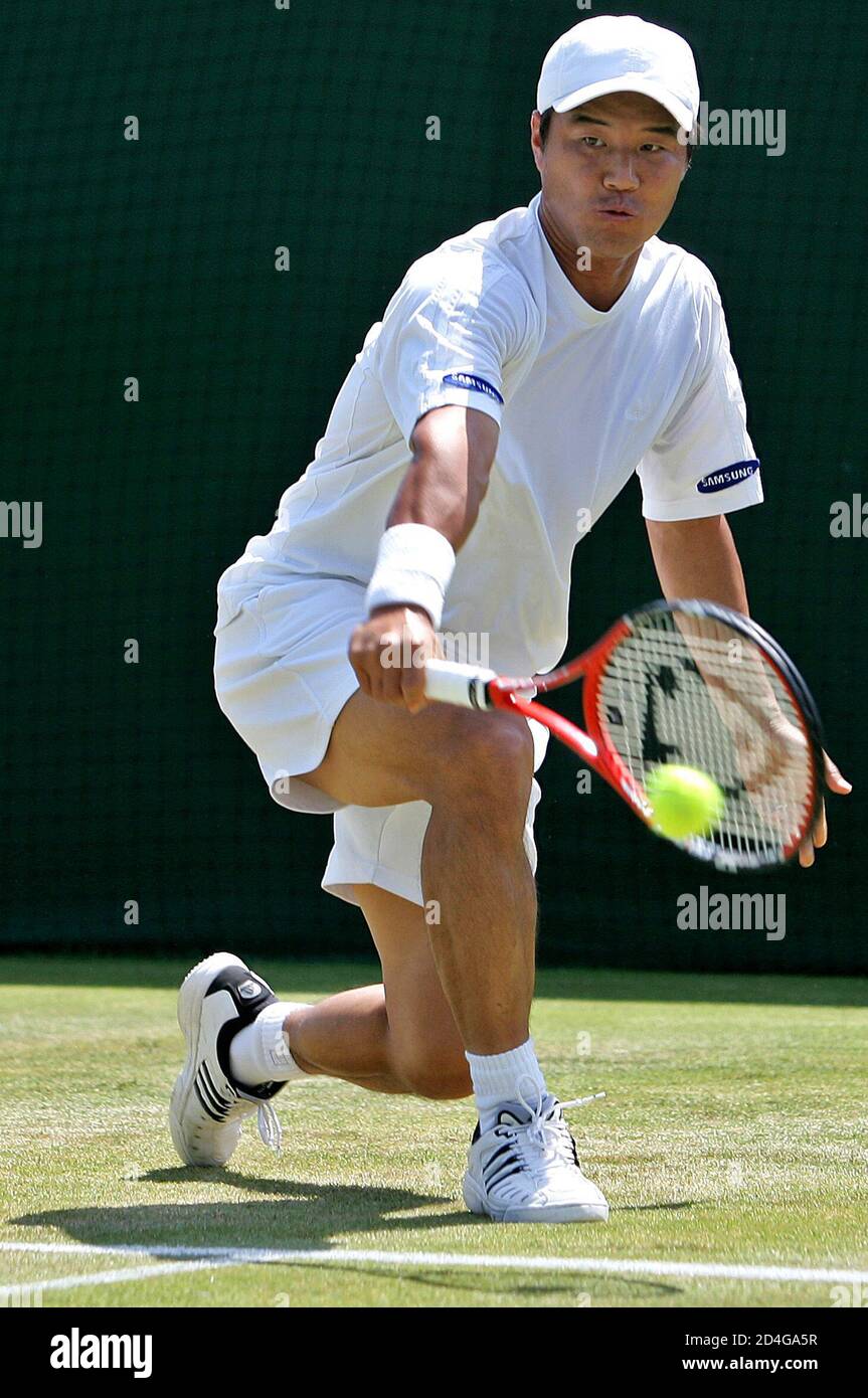 Hyung-Taik Lee of South Korea returns the ball to Spain's Juan Carlos  Ferrero in their second round men's singles match at the Wimbledon tennis  championships in London June 22, 2005. REUTERS/Toby Melville
