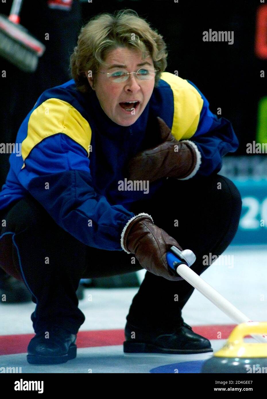 Swedish skip Elisabet Gustafson yells to sweepers during match against  Canada in the women's curling competition at the Salt Lake 2002 Olympic  Winter Games in Ogden, February 11, 2002. The women's gold