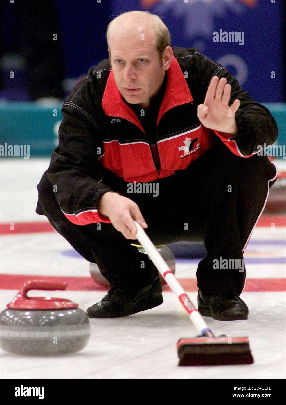Canadian skip Kevin Martin watches the action of the Canada-Sweden match in  the men's round robin session six of Salt Lake 2002 Winter Olympic Games  men's curling in Ogden, February 14, 2002.