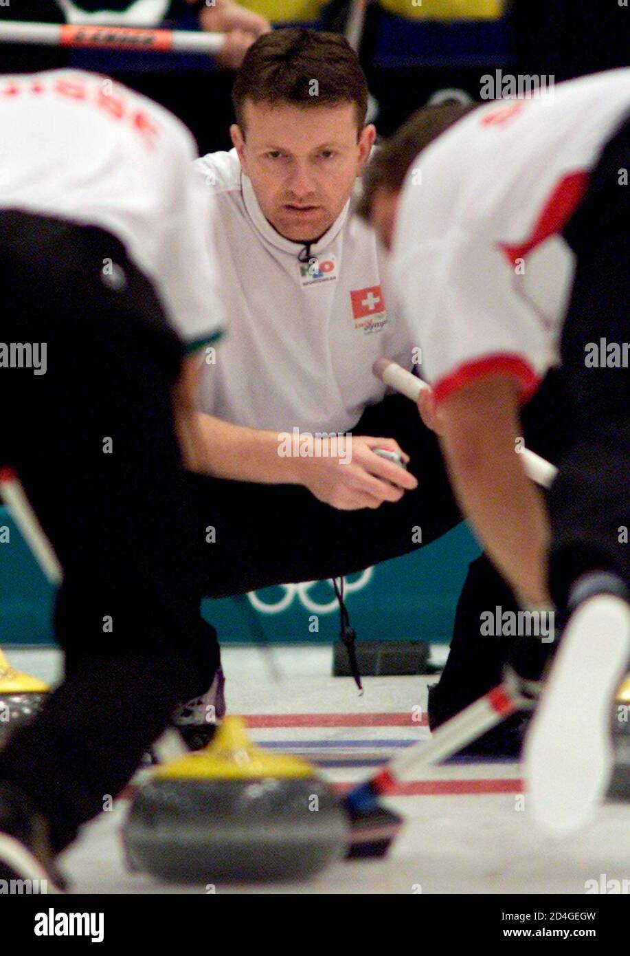 Swiss skip Andreas Schwaller watches the stone during the Salt Lake 2002  Olympic Winter Games bronze medal curling match against Sweden at the Ice  Sheet in Ogden February 22, 2002. REUTERS/Andy Clark