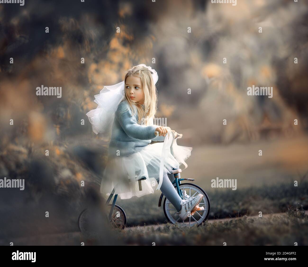 runaway Bride, girl in a veil and bridal suit rides a bicycle Stock Photo