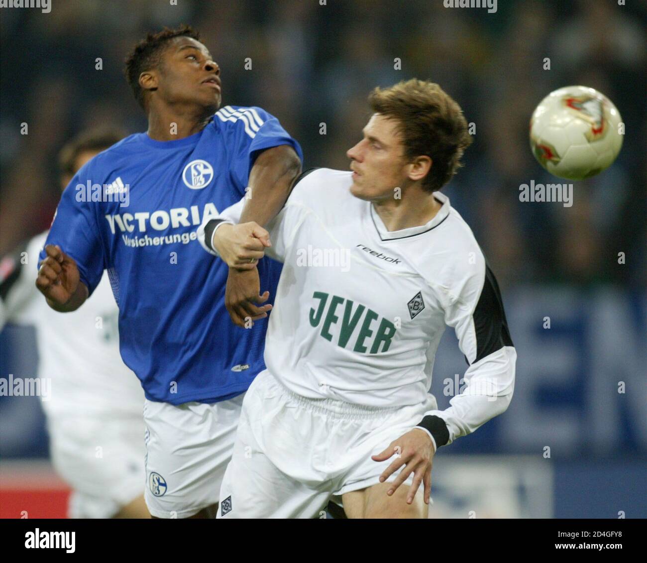MPENZA OF SCHALKE AND KORELL OF MOENCHENGLADBACH HEAD THE BALL DURING A GERMAN SOCCER CUP MATCH IN GELSENKIRCHEN. Stock Photo