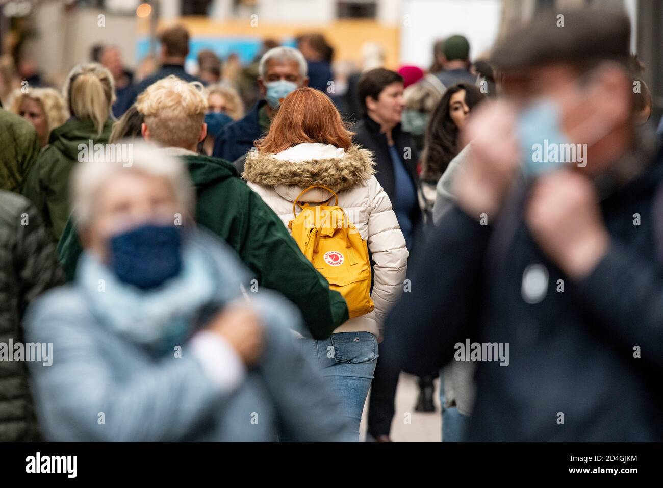 09 October 2020, Hamburg: Passers-by, some of whom are wearing mouth-and-nose protection, walk through the pedestrian zone on Spitalerstraße. Photo: Axel Heimken/dpa Stock Photo
