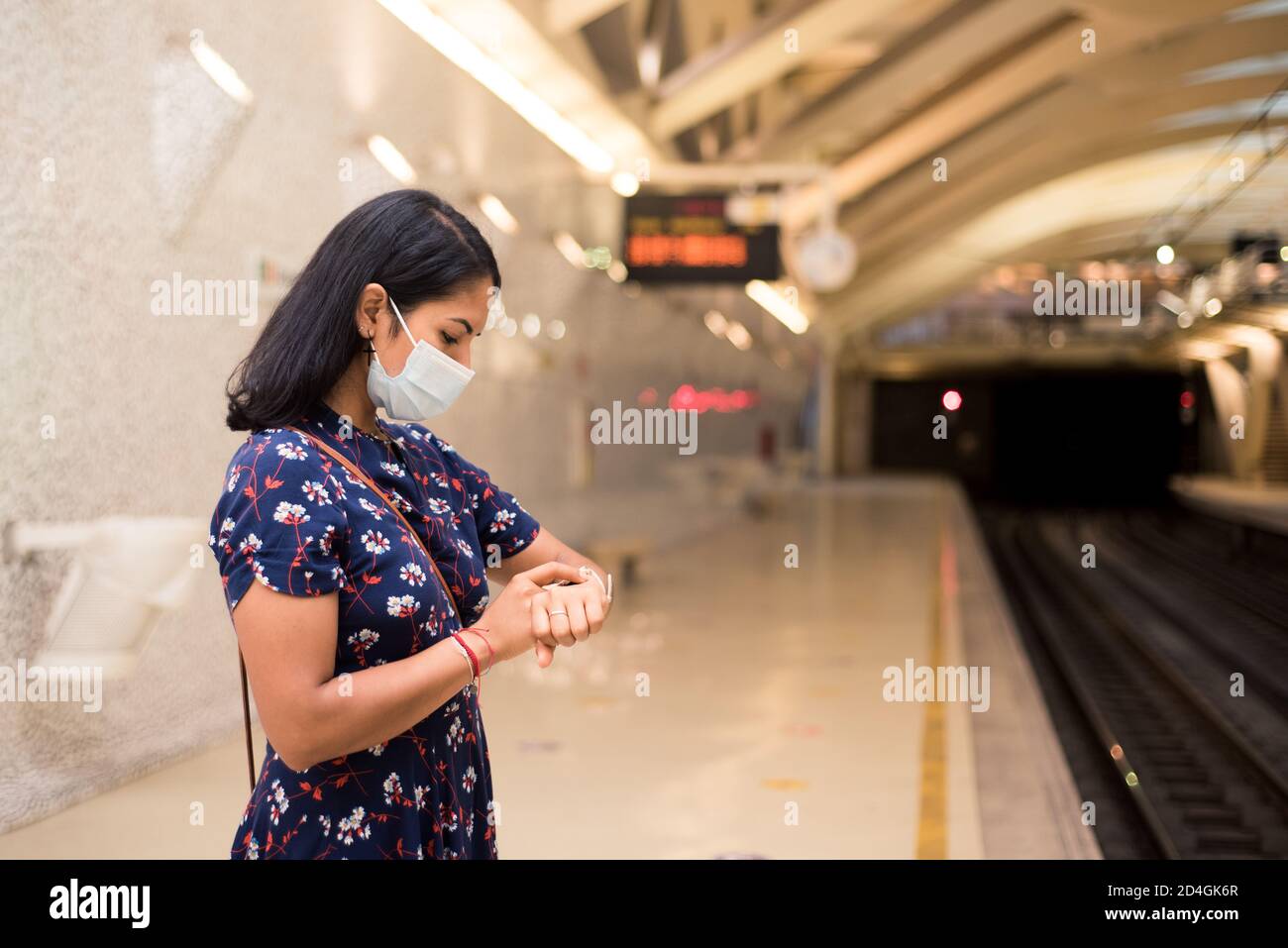 Closeup of a young female wearing a facial mask and watching to the ...