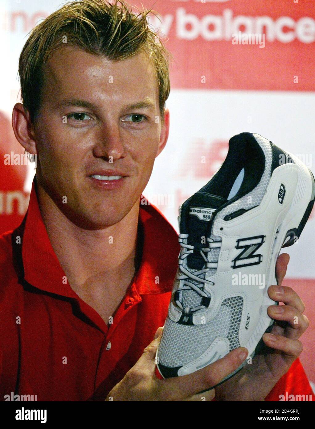 Australian fast bowler Brett Lee displays the new sports shoe by New Balance,  during its launch in Bombay May 2, 2005. Lee launched the new Spring Summer  'New Balance' sports wear collection