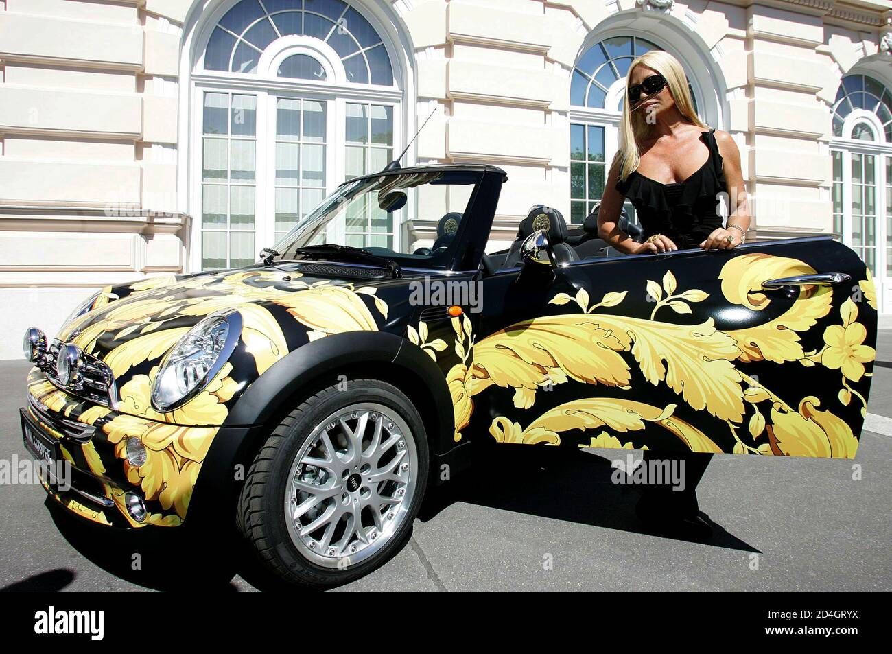Italian fashion designer Donatella Versace presents a Versace-designed Mini  Cooper to photographers in Vienna May 20, 2005. The car will be up for  auction at the 13th annual 'Life Ball', which collects