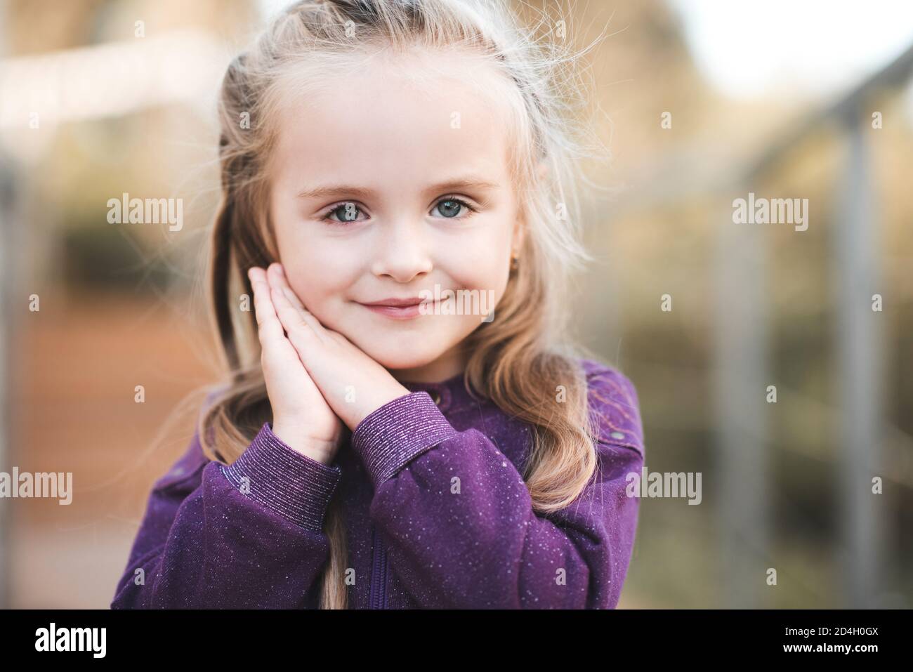 Cute baby girl 3-4 year old wearing stylish white dress sitting in bed in  room. Looking at camera Stock Photo - Alamy
