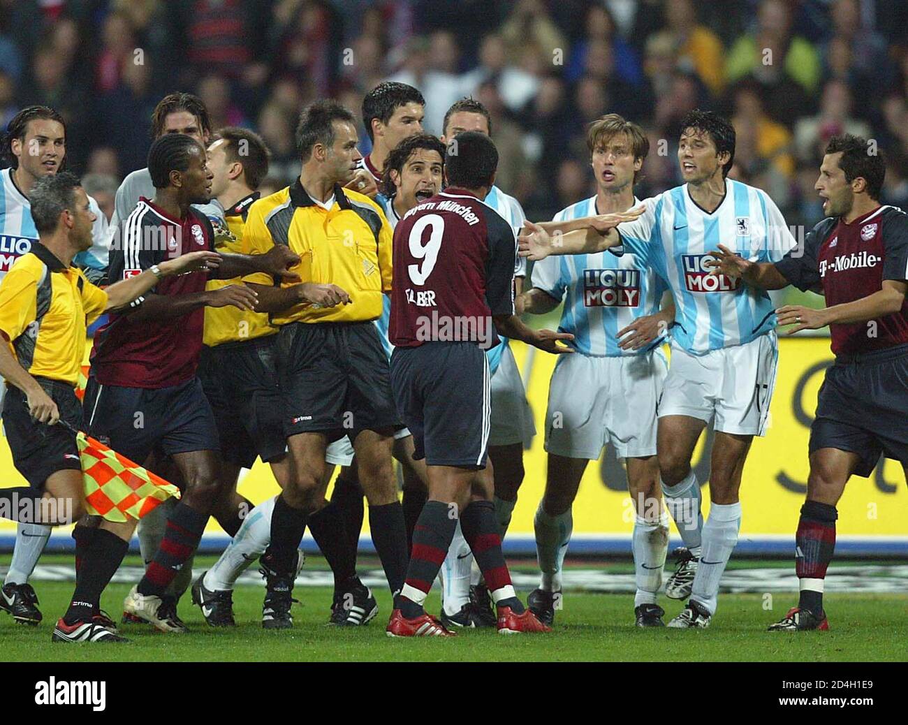 Bayern Munich's Brazilian forwarder Giovanne Elber (C,No9) argues with Harald Cerny (3rdR) and Daniel Borimirov of 1860 Munich while referees try to seperate the players during the 195th prestigious match of both Munich clubs in Munich's Olympic stadium, September 10, 2002. REUTERS/Kai Pfaffenbach REUTERS ADVISES THAT ACCORDING TO THE DFL THIS IMAGE CAN NOT BE PUBLISHED ONLINE OR ON A MOBILE PLATFORM FOR THE DURATION OF THIS GAME WITHOUT ITS AUTHORITY. PLEASE CONTACT THE DFL DIRECTLY FOR FURTHER INFORMATION REUTERS  KP/WS Stock Photo