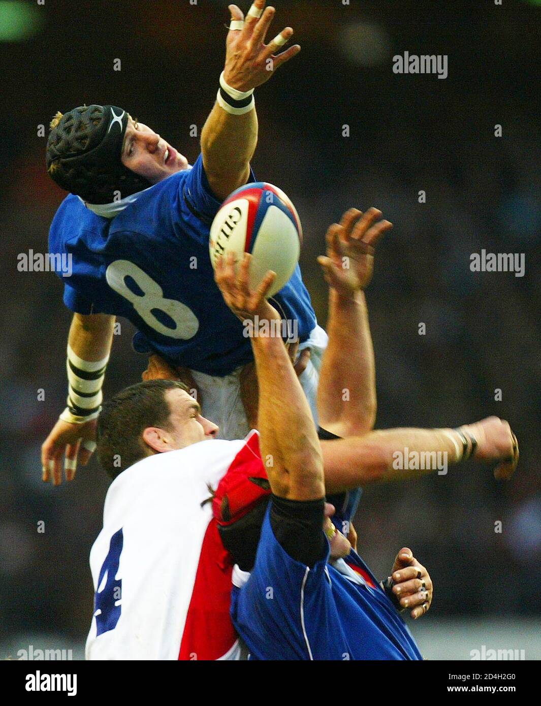 England captain Martin Johnson (C) fights for the ball against France's Imanol Harinordoquy (8) and Serge Betsen (R) during their Six Nations rugby union match at Twickenham in London, February 15, 2003. REUTERS/Russell Boyce Pictures of the month February 2003  RUS/ASA Stock Photo