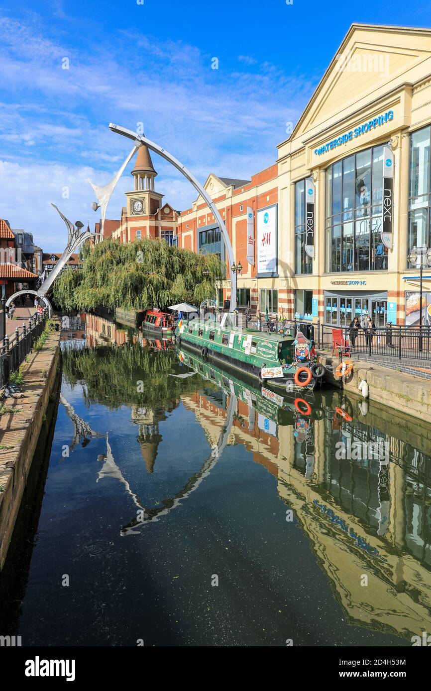The Waterside Shopping Centre, Empowerment sculpture, and barges or narrowboats on the River Witham, City of Lincoln, Lincolnshire, England, UK Stock Photo