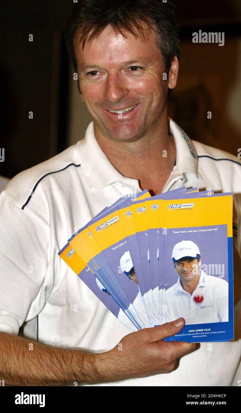 Steve Waugh, former captain of the Australian cricket team, holds pamphlets at the launch of new schemes for an insurance company during a news conference in Bombay May 31, 2004. Waugh, who retired in January as the world's most-capped test player, is the brand ambassador for an insurance company. REUTERS/Punit Paranjpe  PP/FA Stock Photo