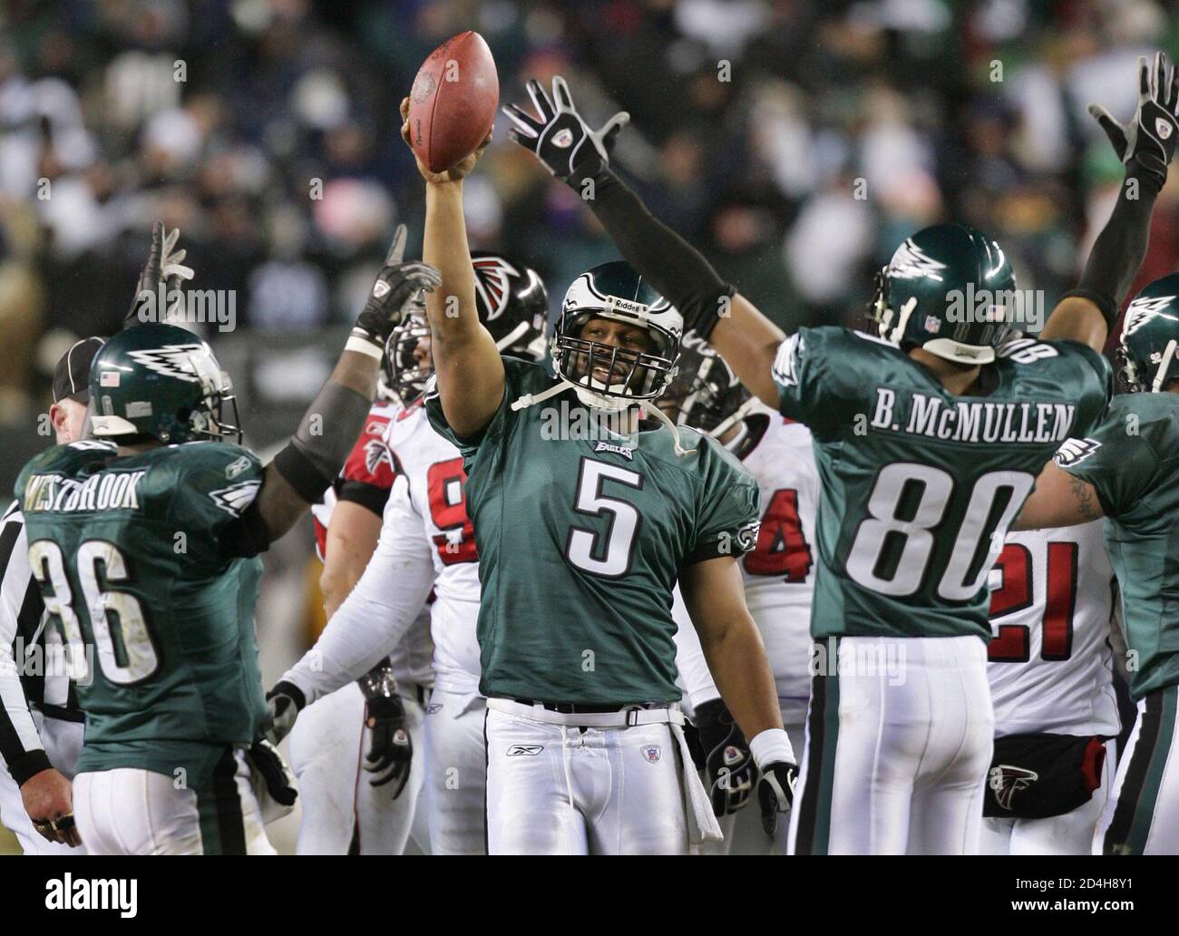 Philadelphia Eagles quarterback Donovan McNabb (5) celebrates with  teammates Brian Westbrook (L) and Billy McMullen, after winning their NFC  championship game against the Atlanta Falcons, in Philadelphia, January 23,  2005. The Eagles