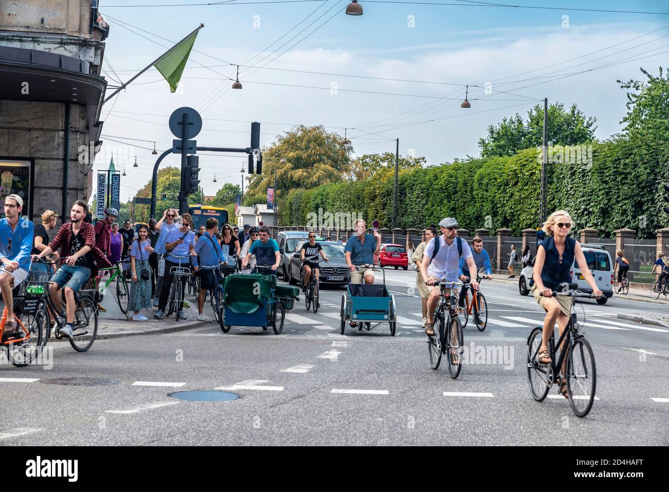 Copenhagen, Denmark - August 27, 2019: Street with people on bicycle and cargo bike cycling in the old town of Copenhagen, Denmark Stock Photo