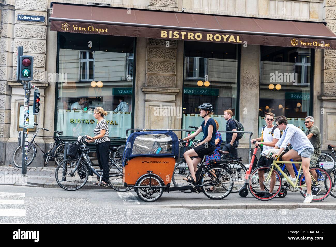 Copenhagen, Denmark - August 27, 2019: Street with people on bicycle and a Babboe cargo bike waiting at a red light in the old town of Copenhagen, Den Stock Photo