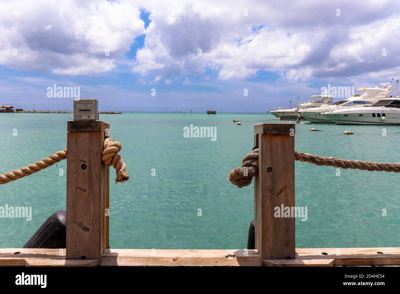 An Arubian dock in front of the Caribbean sea. Stock Photo