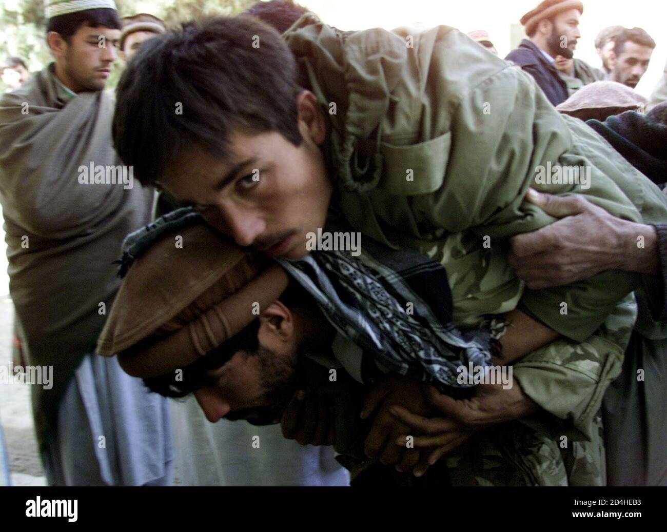 Northern Alliance Soldier Carries His Wounded Friend Into The Hospital In Taloqan November 26 2001 The Northern Alliance Said On Monday Its Forces Had Seized The City Of Kunduz The Last Bastion