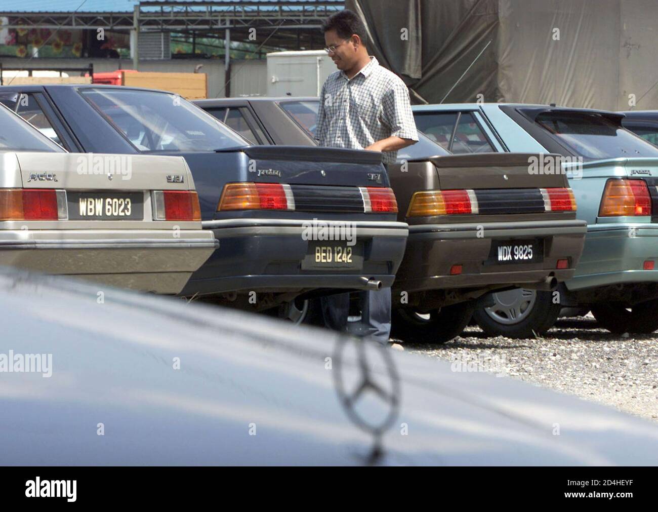 A Man Looks At The Second Hand Car On Sale At A Used Car Dealer In Kuala Lumpur March 29 2002 Malaysian Automakers On Friday Stood By Their Forecast Of A Three