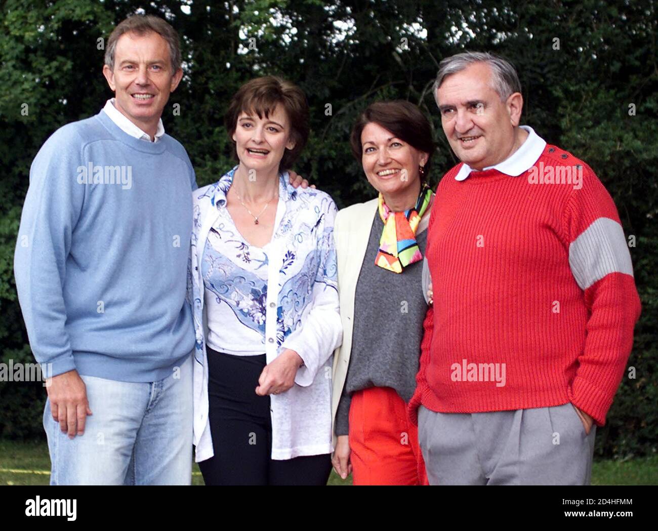 British prime Minister Tony Blair (L) and his wife Cherie pose with French prime Minister Jean-Pierre Raffarin (R) and his wife Anne-Marie during a private meeting in castle of 'Lagrezette' in Caillac, southwestern France, August 12, 2002. Blair is currently on holiday in the area. Stock Photo