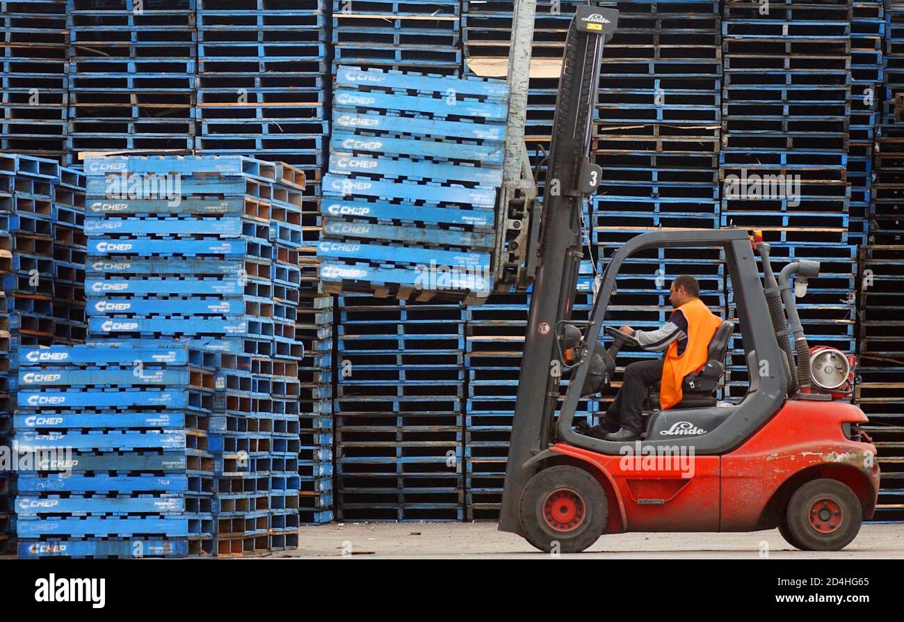 A Forklift Operator Stacks Empty Wooden Pallets At A Chep Pallet Depot Owned By Brambles Industries