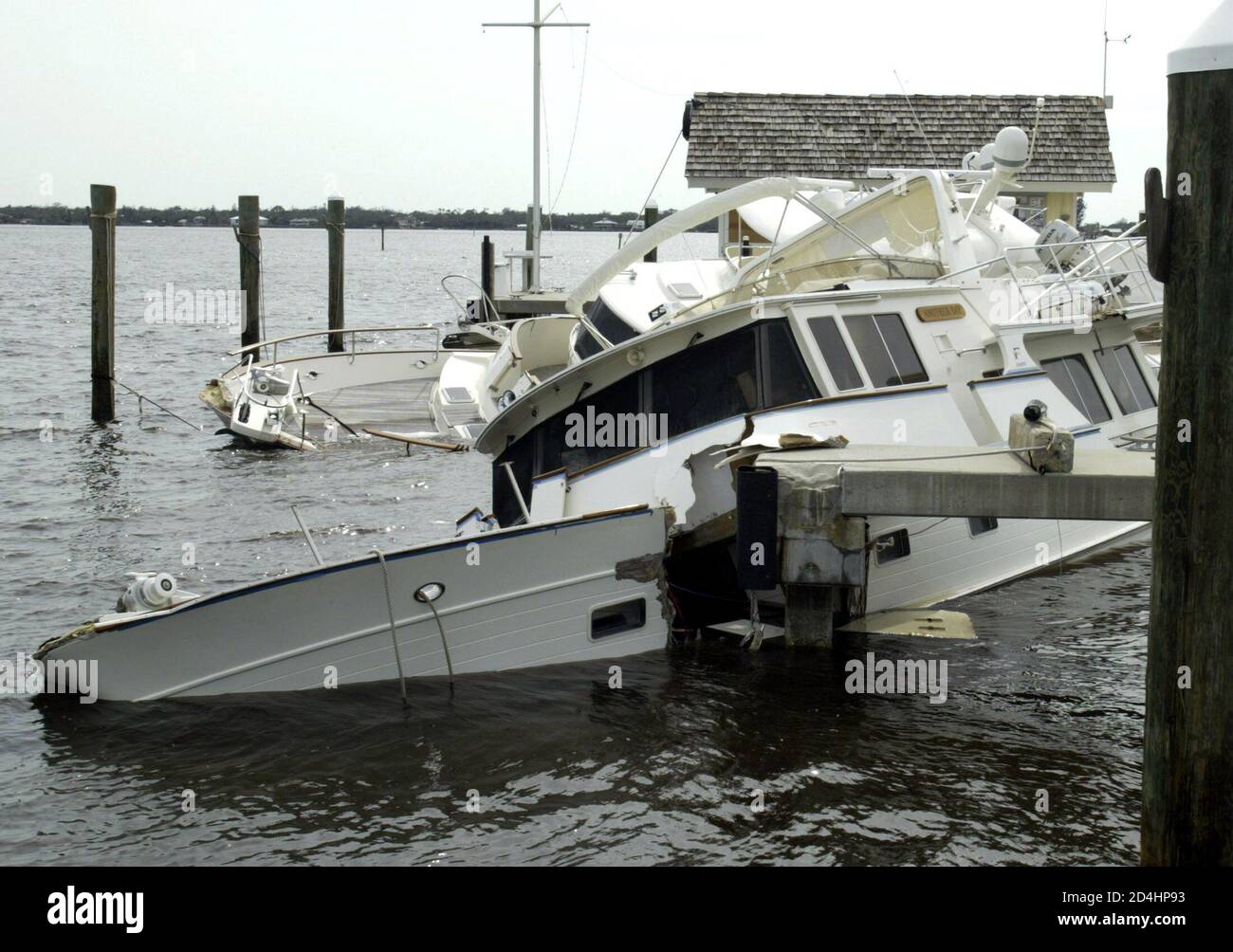 A yacht named 'Another Day' lies sunk as a result of Hurricane Frances, with its hull smashed in on Hutchinson Island near Port St. Lucie, Florida, September 6, 2004. [President George W. Bush will visit Florida on September 8 and has asked the U.S. Congress for two billion dollars in emergency aid for the hurricane ravaged state.] Stock Photo