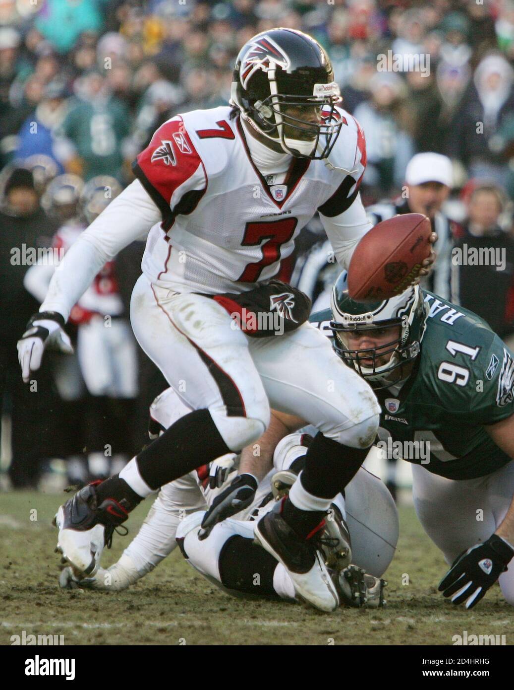 Atlanta Falcons quarterback Michael Vick (7) runs with the ball past  Philadelphia Eagles defensive tackle Sam Rayburn, during the second quarter  of their NFC championship game in Philadelphia, January 23, 2005.  REUTERS/Mike