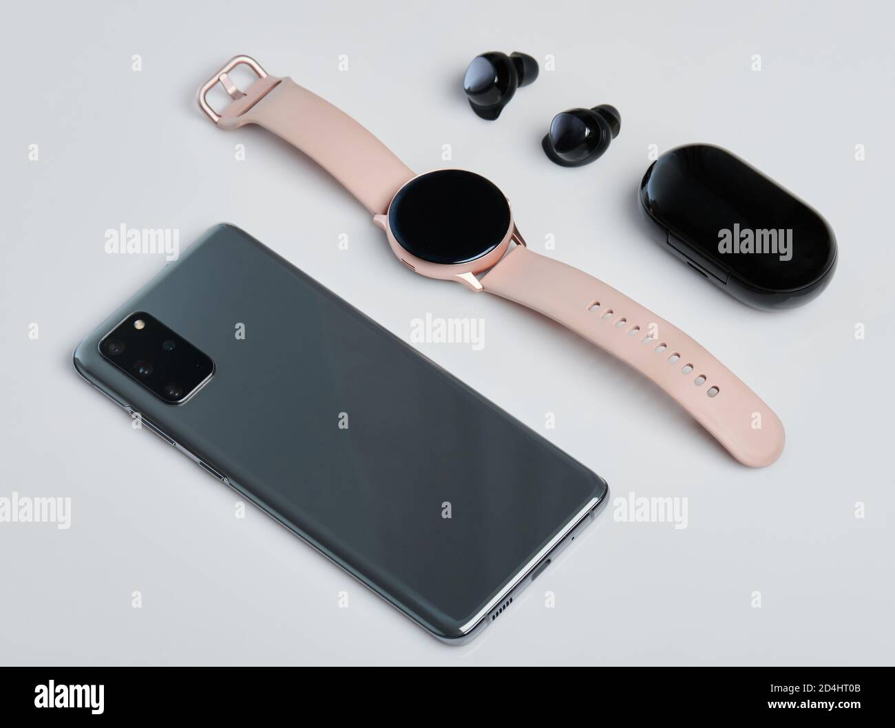 Smartphone smartwatch and earphones  isolated on white studio background Stock Photo