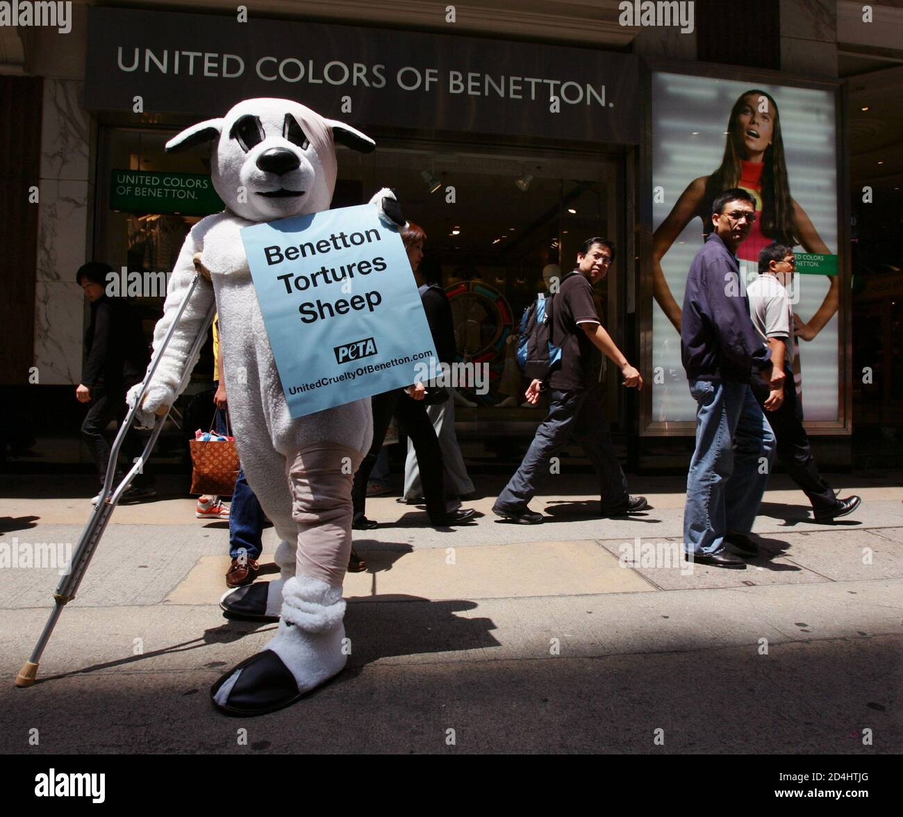 A member from an animal protection group, People for the Ethical Treatment  of Animals (PETA), wears a sheep costume outside a Benetton outlet in Hong  Kong April 7, 2005. The group protested