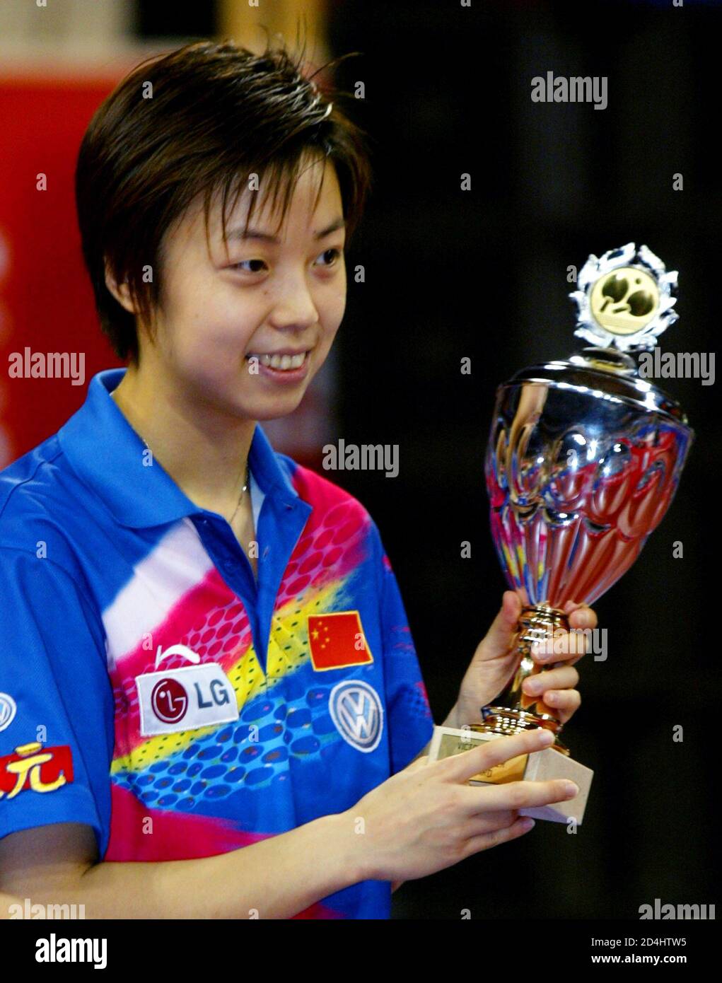 World champion Zhang of China holds her trophy as she celebrates being
