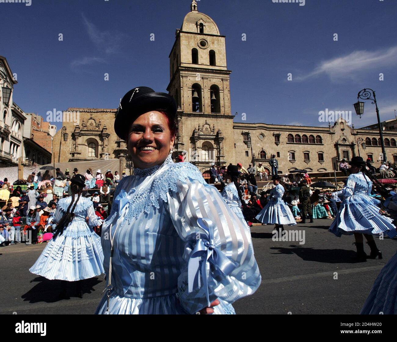 Bolivian women dance in front of the San Francisco church as they take part in the 'El Senor del Gran Poder' (Feast of the Great Power of Jesus) festival in La Paz, Bolivia May 21, 2005. The feast, which is one of the most important and expressive manifestations of La Paz's cultural identity, had its origins in the arrival in the Ch'ijini area of a canvas showing a three-faced figure. The image was reinterpreted according to the Aymara tradition to mean that one asked the face on the right for good things, the left for negative things, while one prayed to the center face. The Catholic Church h Stock Photo
