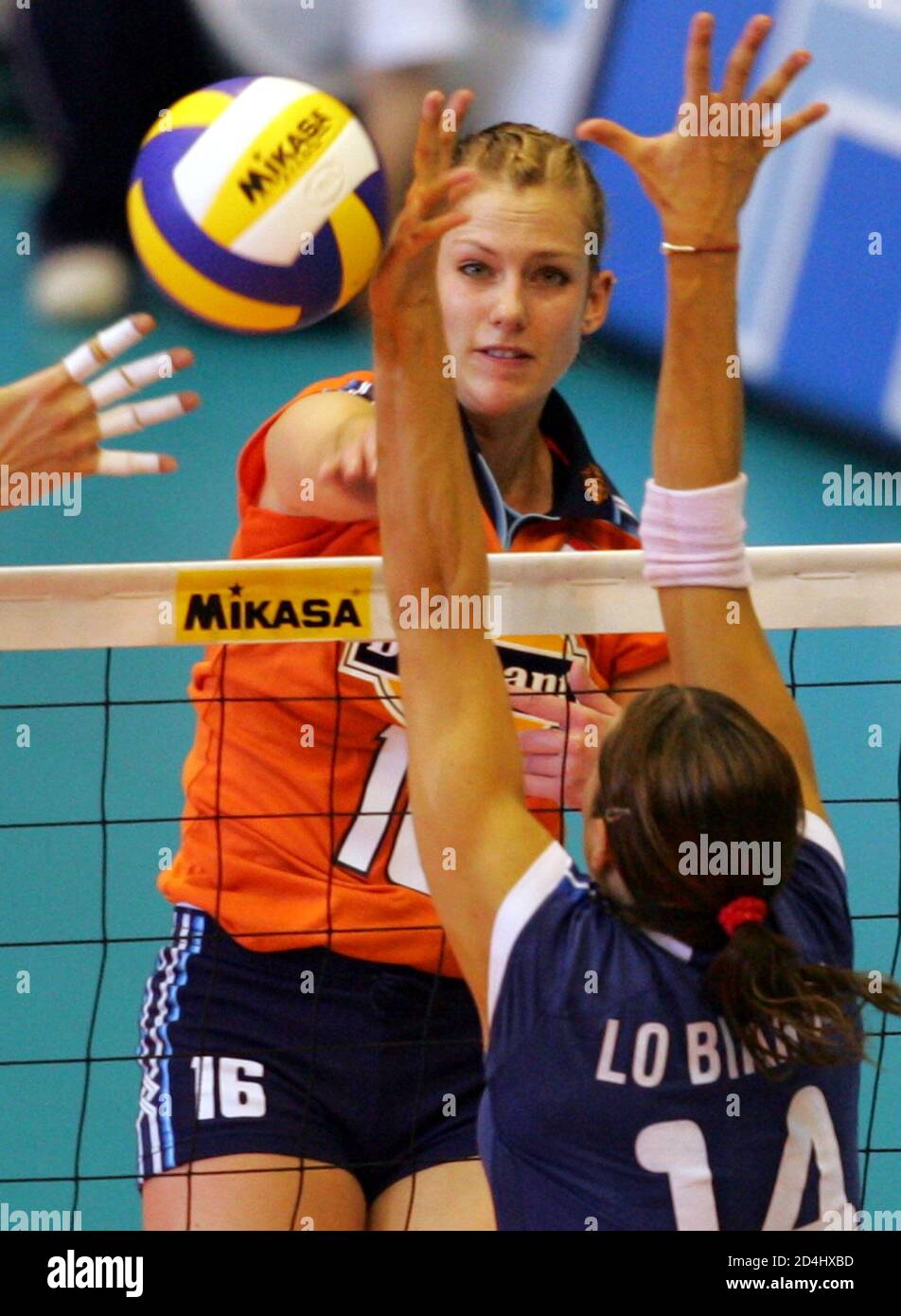 The Stam spikes the ball Italy's Lo Bianco in the World Grand Prix women's volleybal in Sendai, Japan. The Netherlands' Debby (L) spikes the ball past Italy's blocker Eleonora