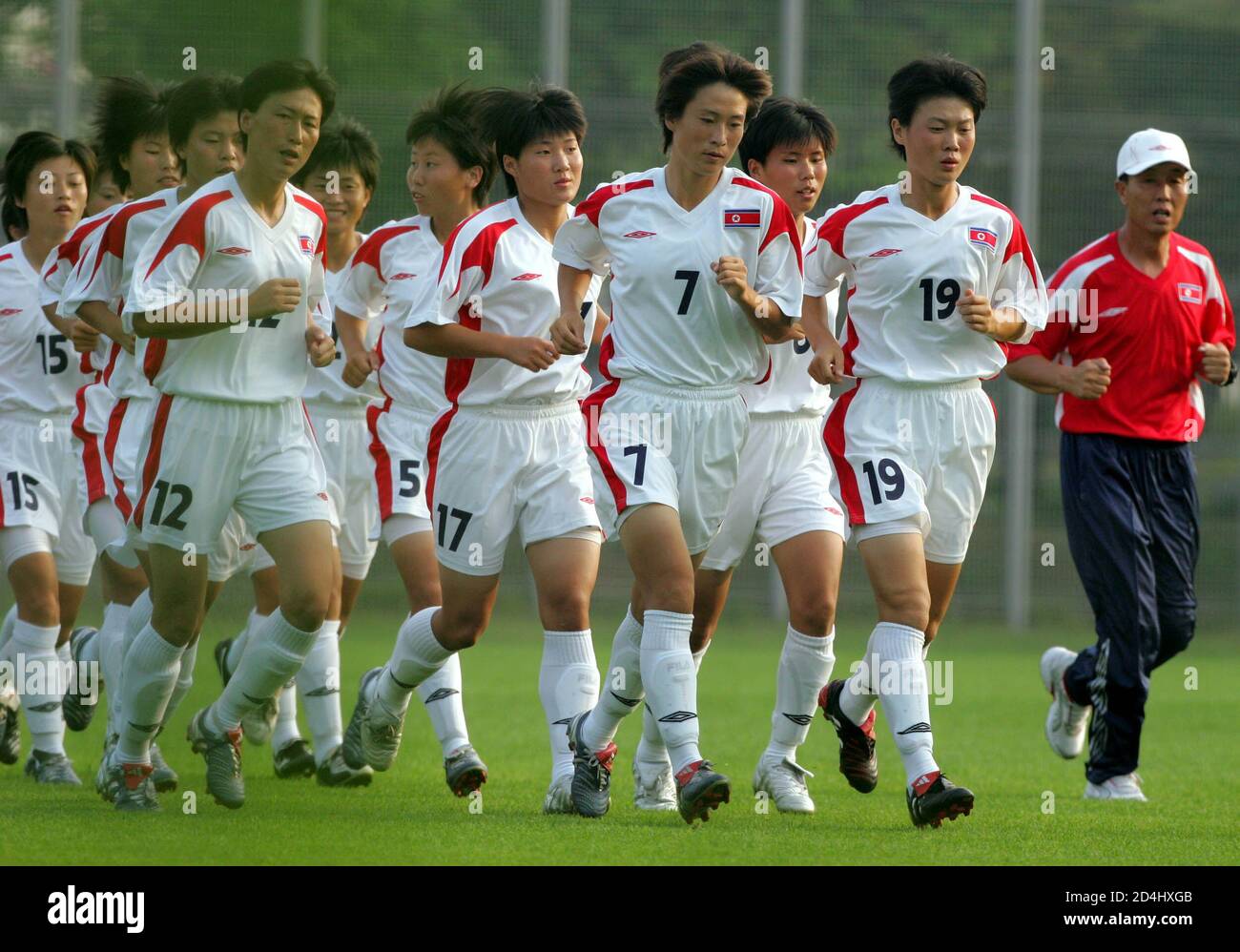 North Korean Women S National Soccer Team Players Run With Coach Kim Bong Il R During A Practice In Seoul July 26 05 North Korea S National Men S And Women S Soccer Teams Arrived In South