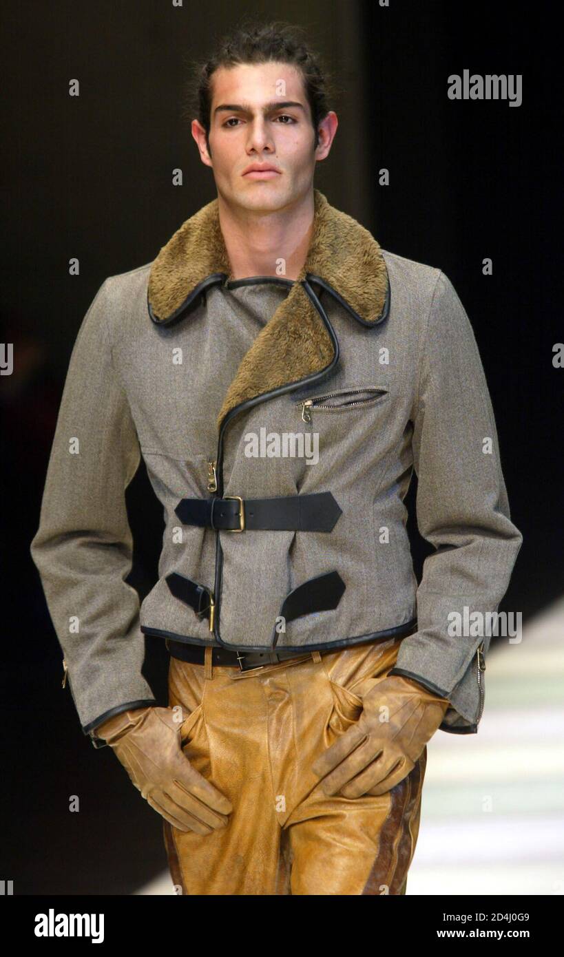 A model displays a short jacket with leather trousers as part of Emporio  Armani Autumn/winter ready-to-wear men's collection 2002/2003 in Milan  January 16, 2002. [The Milan fashion shows will run until January