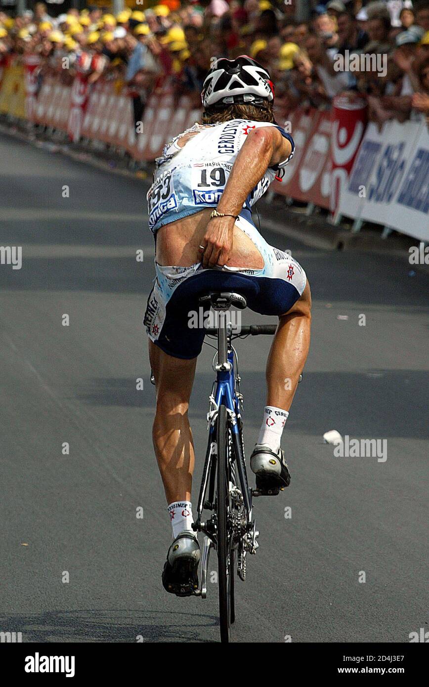 Gerolsteiner Team Rider Rene Haselbacher Of Austria Rides To The Finish Line Holding His Torn Shorts After He Crashed In The Finish Of The Third Stage Of The Tour De France Cycling
