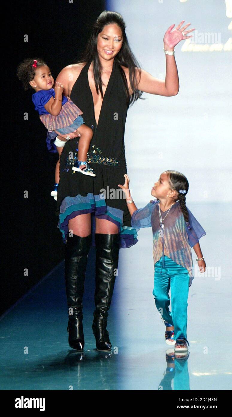 Designer Kimora Lee Simmons waves with her kids at the end of her Baby Phat  Spring 2004 fashion show, September 13, 2003 in New York. Over 100  designers will be showing their
