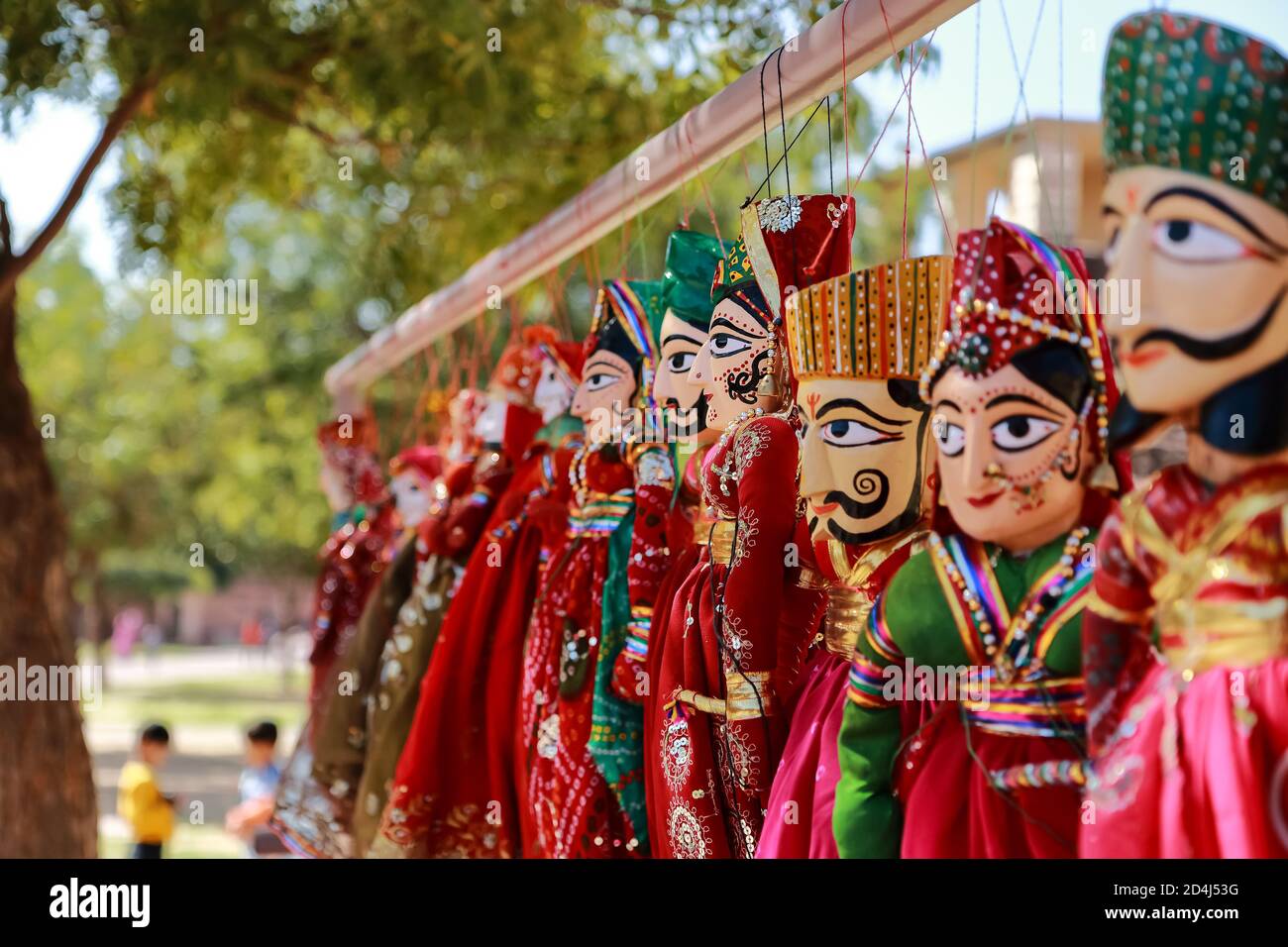 Colorful human face shaped Puppets wearing colorful clothes hanging