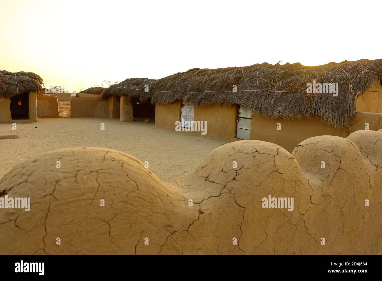A selective focus image of a mud house with thatched roof in an village in Rajasthan India Stock Photo