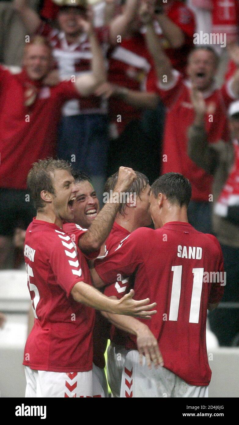 DENMARK JON DAHL TOMASSON CELEBRATE SCORING THE FIRST GOAL AGAINST SWEDEN  DURING EURO 2004 GROUP C SOCCER MATCH IN PORTO. Denmark Jon Dahl Tomasson  (C) and his team mates Daniel Jensen (L),Niclas