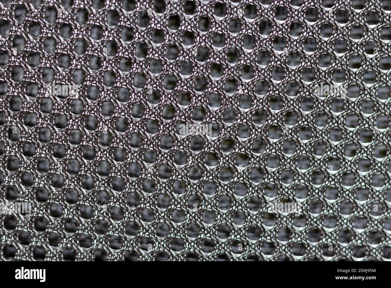 Abstract texture of black metal mesh with fine mesh, curved and deformed. Stock Photo