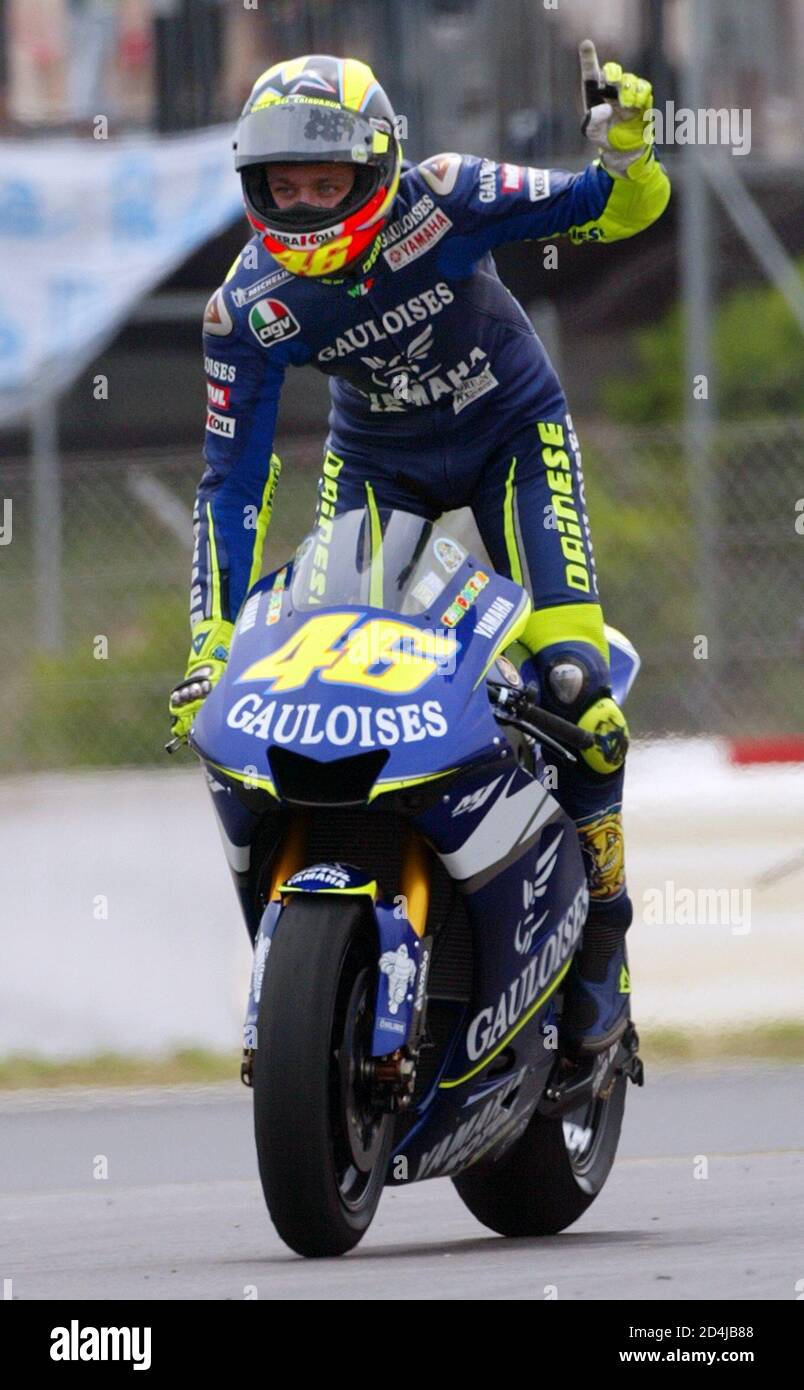 Italian MotoGP rider Valentino Rossi celebrates after winning the Catalan  Motorcycle Grand Prix at Circuit de Catalunya race track near Barcelona  June 12, 2005. Rossi extended his lead at the top of