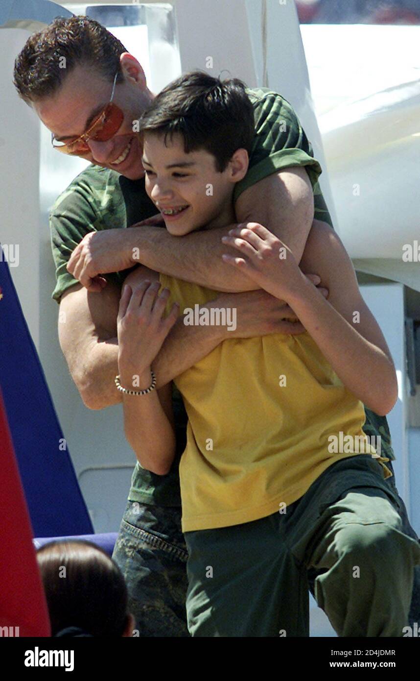 Belgian actor Jean-Claude Van Damme plays with his son Kristopher on the  top deck of the yacht 'The Lady Roxanne' moored in the Cannes port, May 13,  2001. Van Damme is on