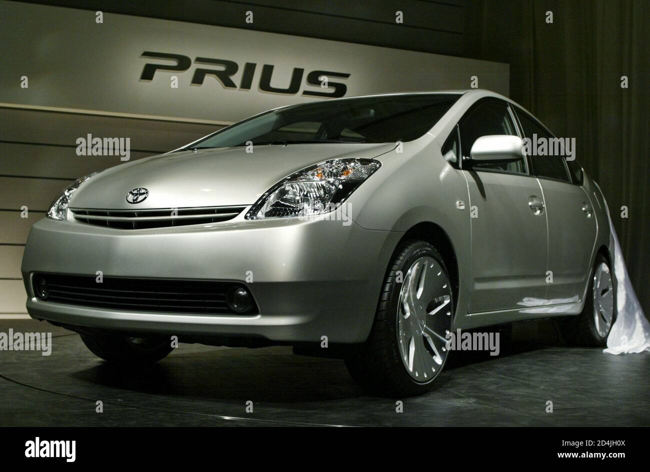 2 PIC:TOK60D  Toyota Motor Corp. unveils its all-new 'Prius' in Tokyo April 17, 2003. The new Prius is equipped with Toyota's new hybrid system THS II that allows either gas or electric modes as well as a mode in which both the gas engine and the electric motor are in operation. REUTERS/Issei Kato Stock Photo