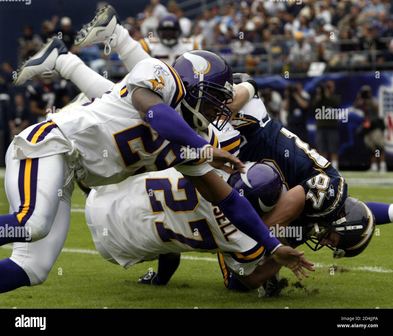 Minnesota Vikings Brian Russell (27) and Denard Williams upend San Diego Chargers wide receiver Tim Dwight (87) during NFL action at Qualcomm Stadium in San Diego, California, November 9, 2003. San Diego upset Minnesota, 42-28. REUTERS/Mike Blake  MB/GAC Stock Photo