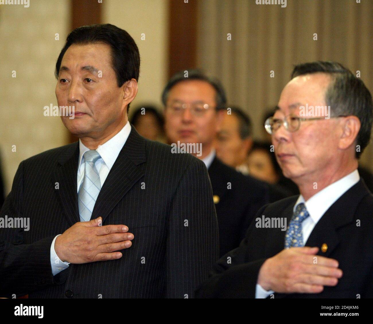 South Korea S Acting President Goh Kun L Salutes The Flag With Lee Hun Jai R Deputy Prime Minister And Minister Of Finance And Economy At A Cabinet Meeting In Seoul March 16 04 South Korea S Acting President Goh Kun L Salutes The Flag With Lee Hun Jai R Deputy Prime Minister And Minister Of Finance And Economy At A Cabinet Meeting In Seoul March 16 04