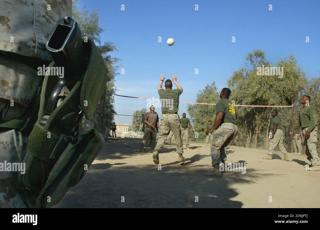U.S Marines from 31st Marine Expeditionary Unit play volleyball in their camp near the restive town of Falluja, 50 kms west of Baghdad December 10, 2004. REUTERS/Shamil Zhumatov  SZH/WS Stock Photo