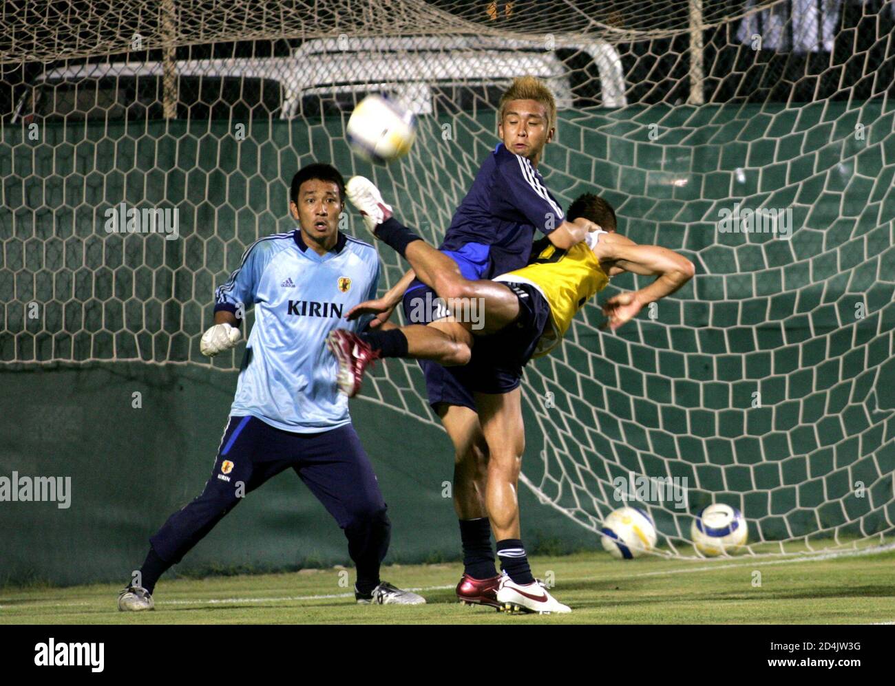 Japanese Players Inamoto Fights For The Ball With Suzuki During Training Session At Bahrain National Stadium In Manama Japanese Players Junichi Inamoto C Fights For The Ball With Takayuki Suzuki R During