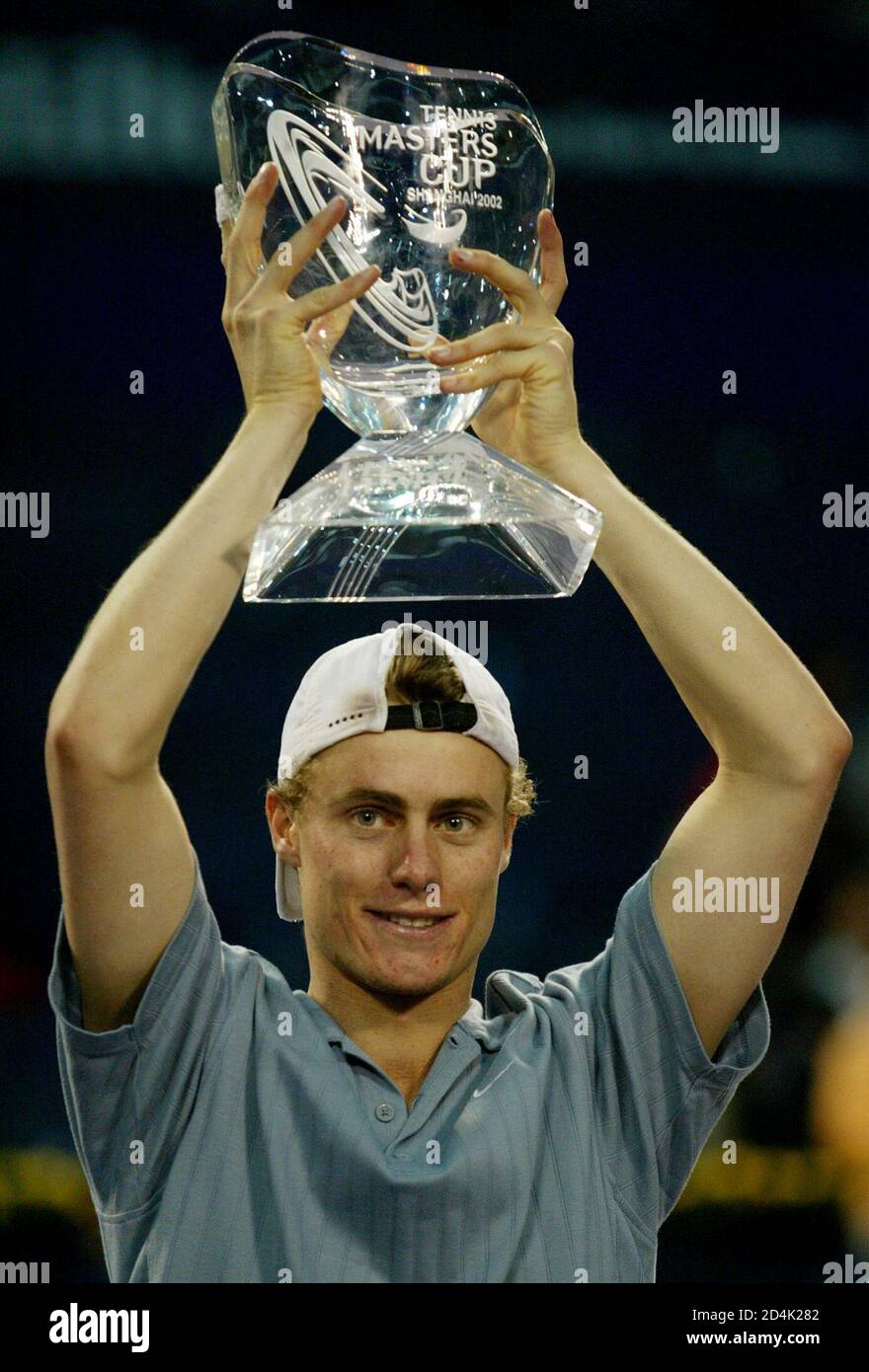World number one Lleyton Hewitt of Australia holds aloft the trophy after  beating Juan Carlos Ferrero of Spain during the final of the Tennis Masters  Cup in Shanghai, China November 17, 2002.