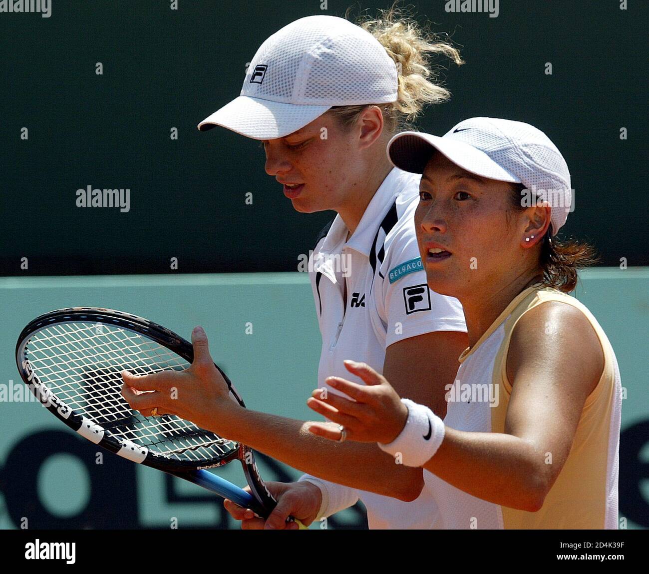 Ai Sugiyama of Japan (R) and Kim Clijsters of Belgium (L) play their  doubles match of the women's French tennis open against [Maja Matevzic of  Slovenia and Henrieta Nagyova of Slovakia] at